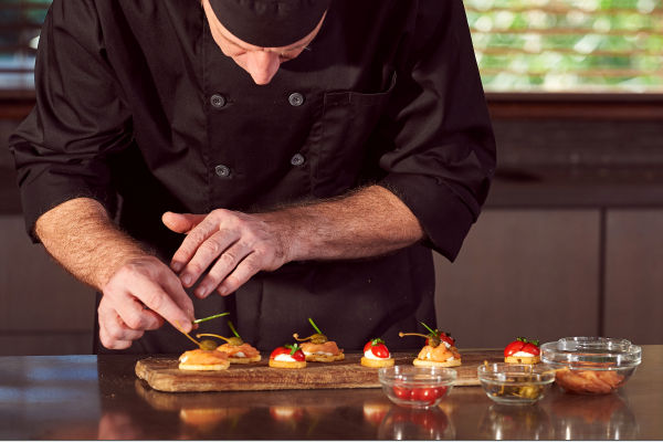 Experienced private chef preparing gourmet meals in a Palo Alto home, provided by Aunt Ann’s In-House Staffing.