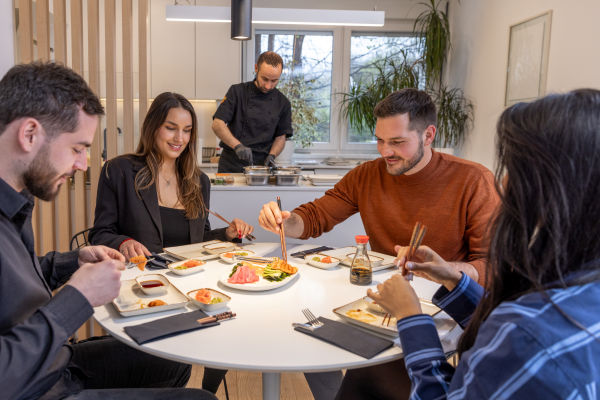 Private chef preparing a gourmet meal, showcasing tailored dining services including formal plated service, family-style meals, and gourmet drop-off options.